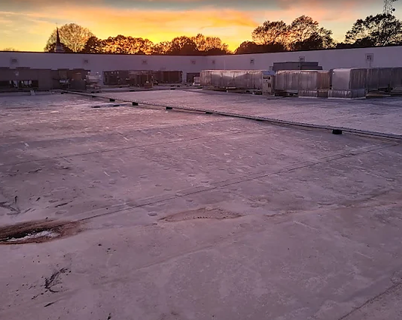 Commercial rooftop HVAC units serviced at sunset